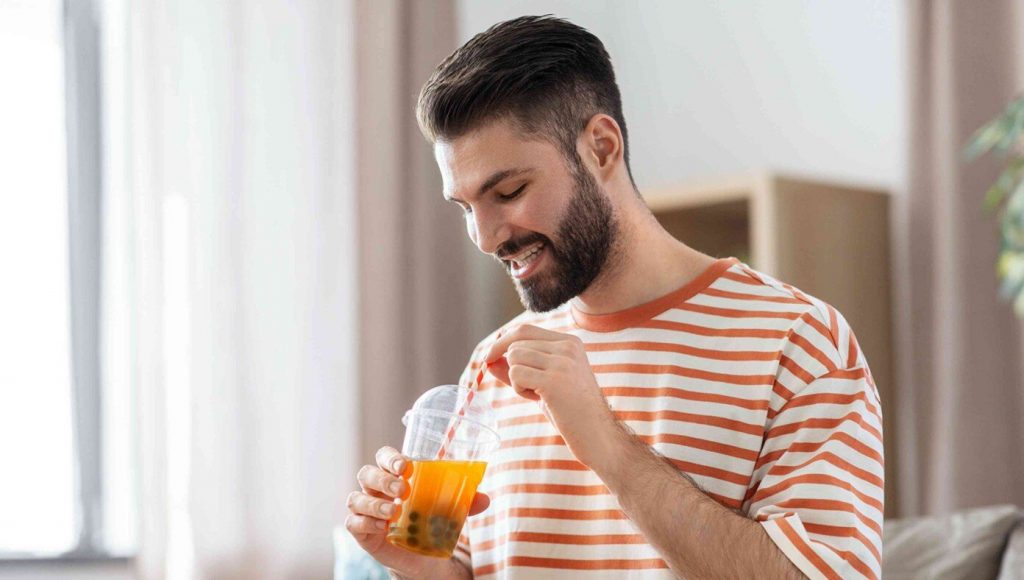 SATIRE – Man Pretends To Enjoy Tea Beverage With Little Slimy Balls Floating In It