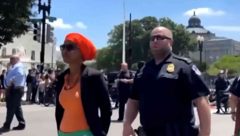 SATIRE – Ilhan Omar Uses Her One Phone Call From Jail To Call Both Her Husband And Her Brother