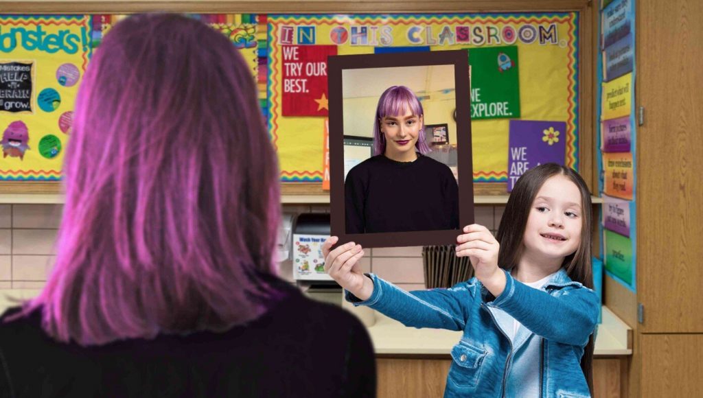 SATIRE – Student Holding Up Mirror To Teacher Telling Class To Get Sex Changes Banned For Hate Speech