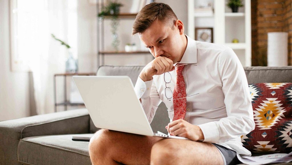 SATIRE – Last Man Wearing Pants While Working From Home Finally Caves