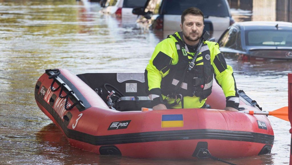 SATIRE – Zelensky Seen On Raft Asking For Donations From Flooded Florida Residents