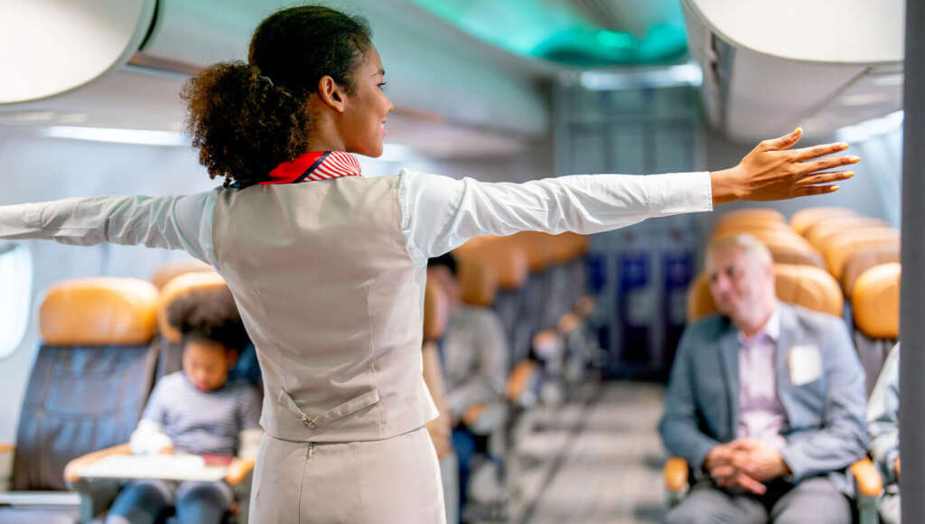 Flight Attendant On A Boeing Gives Presentation On What To Do In The Unlikely Event Of A Safe Landing (Satire)