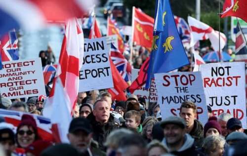 Plan to move migrants into army barracks is delayed over safety fears after hundreds of furious residents marched in protest